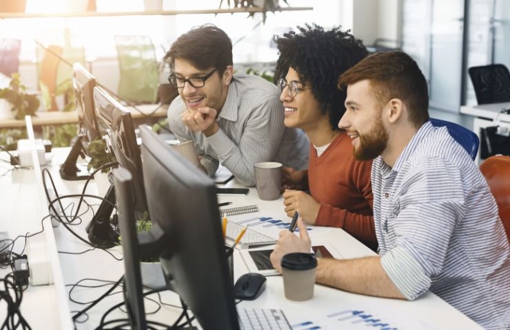 employees sitting at computer desk