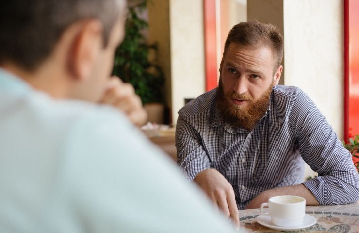 two men sitting at table