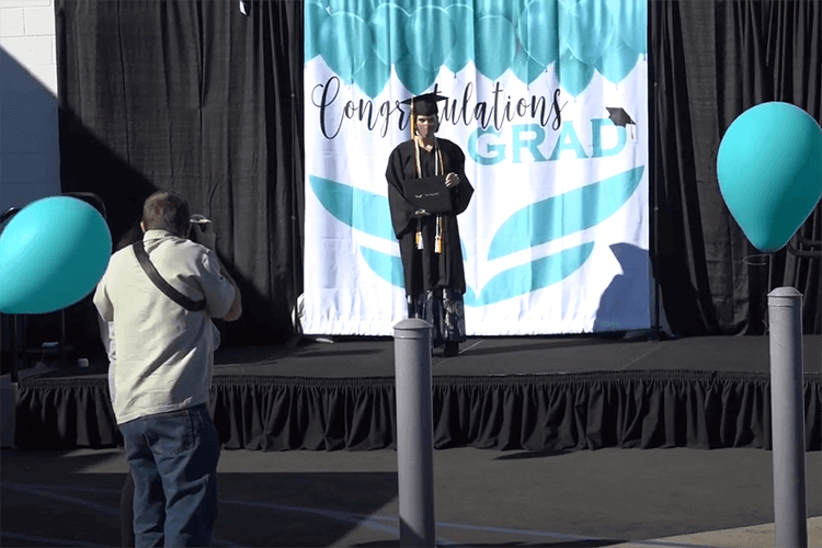 UEI graduate on stage